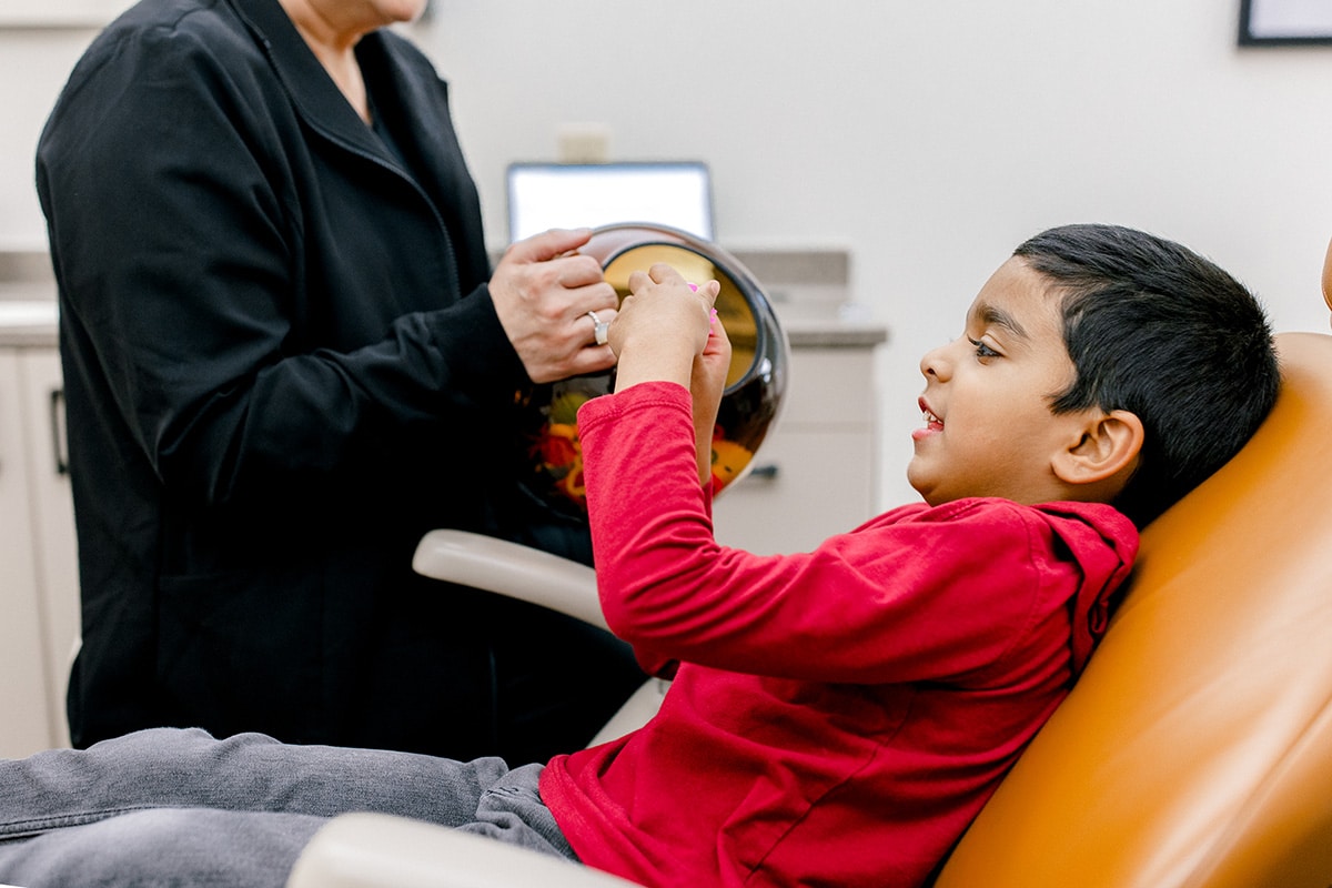 Happy boy sitting in dentist chair