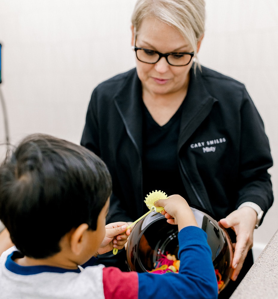 Little boy picking toys
