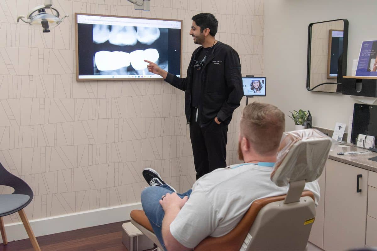 Dentist looking at xrays with patient