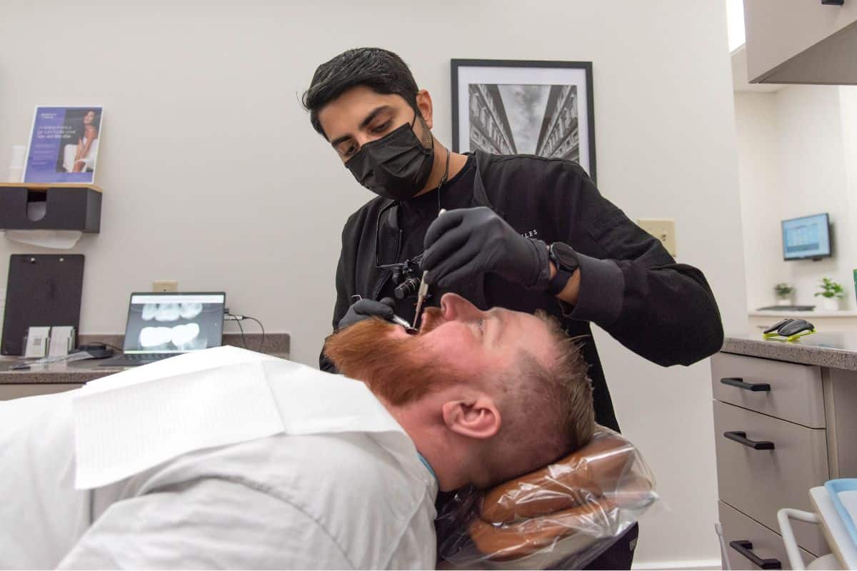 Dentist working on adult male patient