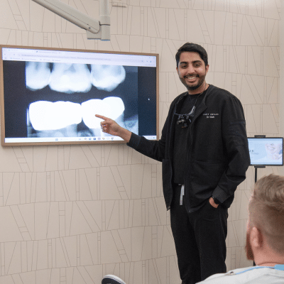 Dr. Rahee shah going over an x-ray with a patient, representing treatment for tooth decay in cary nc