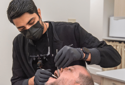 Dr. Rahee shah works on a patient's teeth, representing dental erosion vs cavities