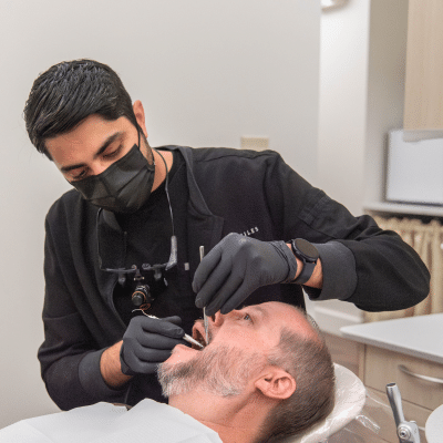 Dr. Rahee shah works on a patient's teeth, representing dental erosion vs cavities