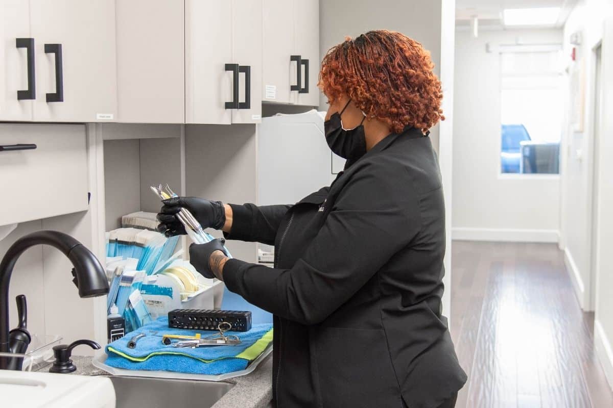 Dental team member preparing sterilized instruments for patient care at cary smiles in cary, north carolina.